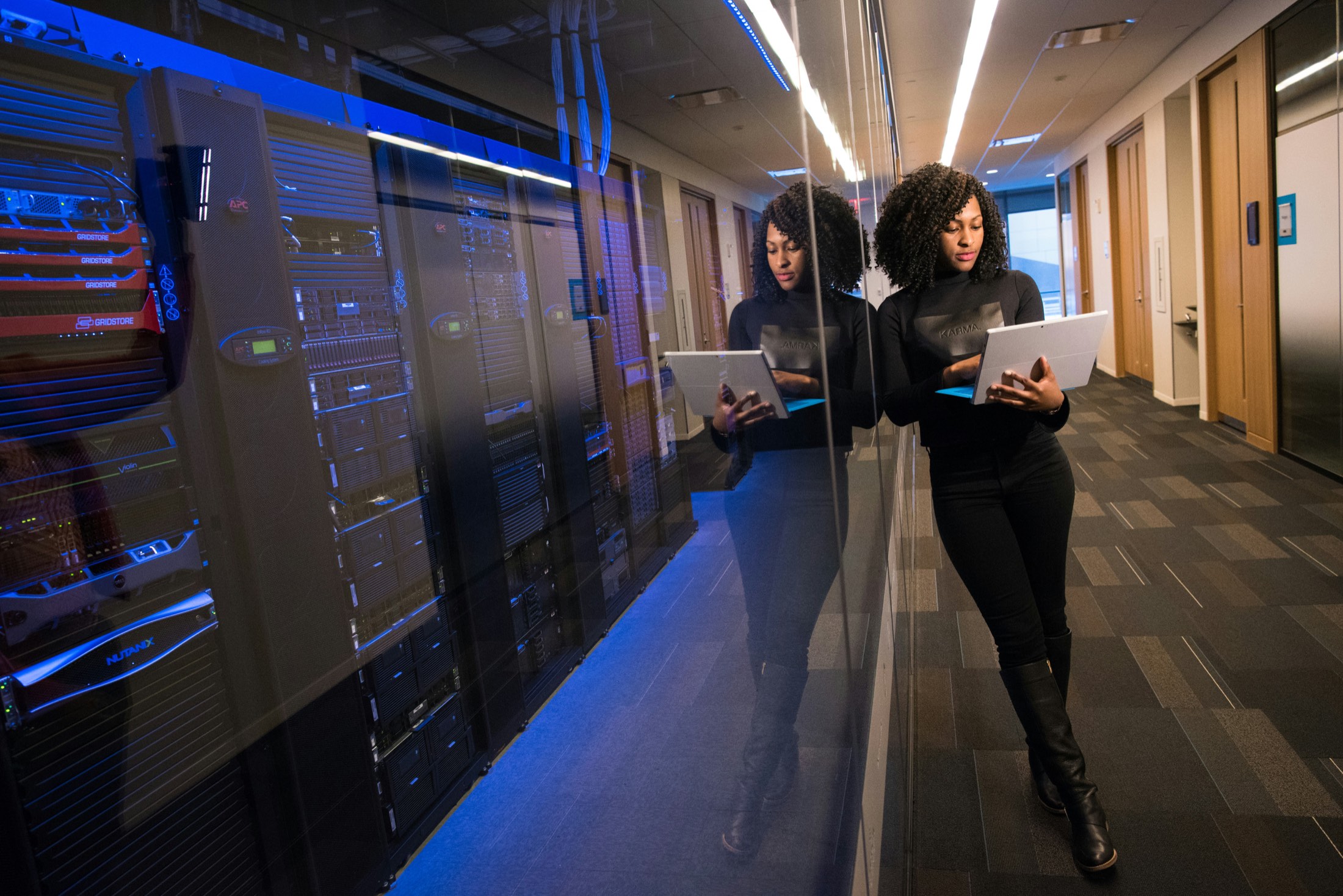 Marketing analyst reviewing data beside server racks